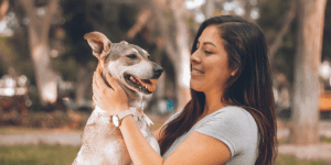 woman playing with dog