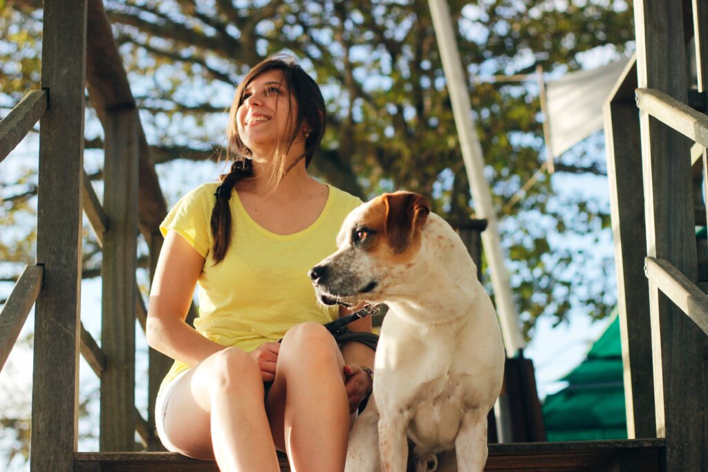 woman sitting outside with dog
