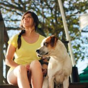 woman sitting with dog outside