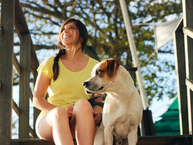 woman sitting with dog outside