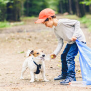 dog and child picking up trash earth day every day