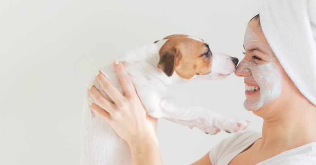 woman in face mask with dog